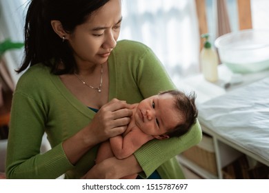 Asian Mother Carry Little Baby Daughter In The House Worried About Skin Condition