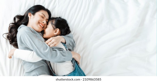 Asian mother and daughter image in bed - Shutterstock ID 2109863585