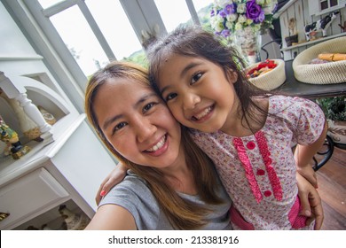 Asian Mother And Daughter Taking Selfie Photograph Together