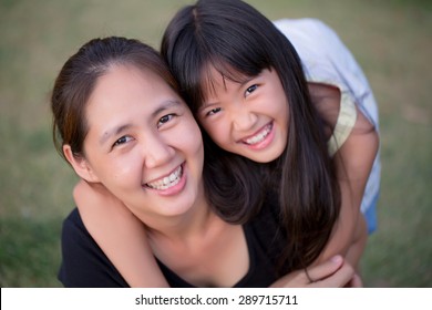 Asian Mother And Daughter Taking Selfie Photograph Together