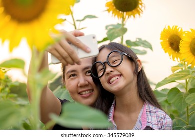 Asian Mother And Daughter Taking Selfie Photograph Together