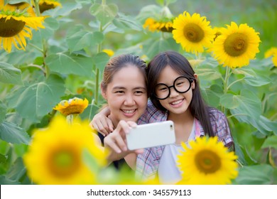 Asian Mother And Daughter Taking Selfie Photograph Together