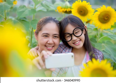 Asian Mother And Daughter Taking Selfie Photograph Together