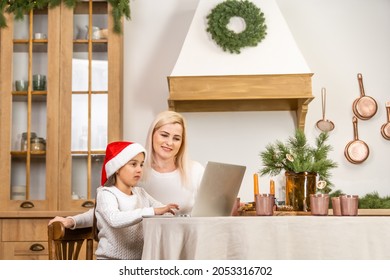 Asian Mother And Daughter Using Laptop Video Call Facetime Chatting Communication To Father With Decorating Christmas Tree In White Room At Home.Smiling Face And Happy To Celebrate New Year Festivel.