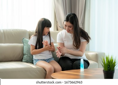 Asian mother and daughter using wash hand sanitizer gel bottle dispenser, Washing hand with Alcohol Sanitizer, prevent the virus and bacterias, Hygiene and Covid-19 virus protection concept.
 - Powered by Shutterstock