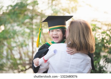 Asian mother embracing her son on graduation day