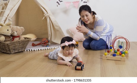asian mother extending her hands to guide her daughter to move in her direction 