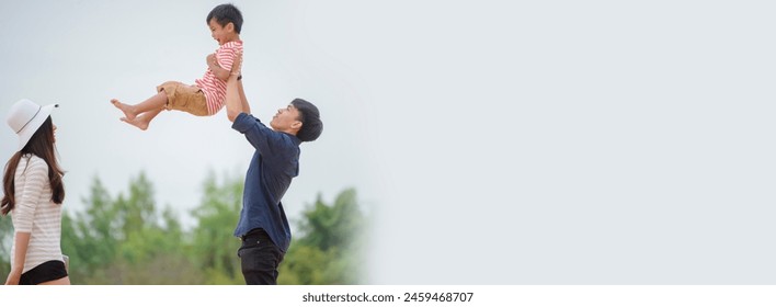 Asian Mother, Father, and Happy son greeting, proud and hug together. Parent and adorable little Child playing together outdoor at beach. Happy Family Concept-banner image. - Powered by Shutterstock