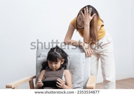 Asian mother feeling worried her daughter game addiction.