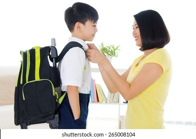 Asian Mother Get Her Son Ready To School