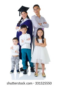 Asian Mother In Graduation Gown.Taking Photo With Family.