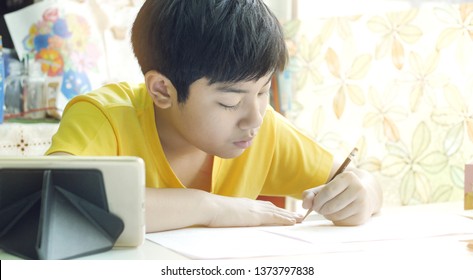 Asian mother helping her son doing homework on white table. - Shutterstock ID 1373797838