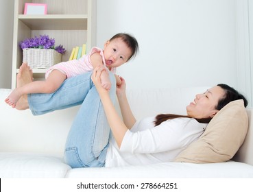 Asian Mother Lifting Up Her Baby