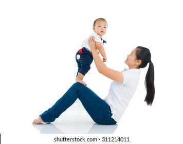 Asian Mother Lifting Up Her Baby