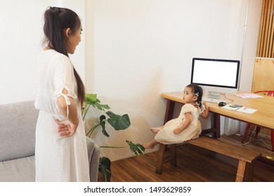 Asian Mother Nagging Her Young Daughter At Home When She Neglects Her Homework But Addicted To Playing Game Online Using Computer For Entertainment Mother Scolding Child And Family Lifestyle Concept