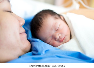 Asian Mother With Newborn Baby In The Hospital