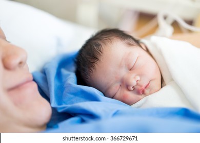 Asian Mother With Newborn Baby In The Hospital