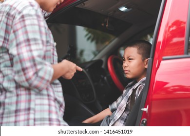 Asian Mother Or Parent Helping Boy Or Pupil To Getting In The Red Car To Ride To School, Boy Don't Want To Go To School, Back To School Concept, Selective Focus.