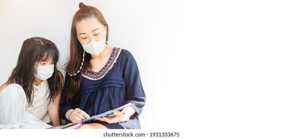 Asian Mother Reading Book With Her Children Kid Lying On Floor At Home During Covid19 Stay Home.Mom Telling Story To Her Child At Kids Club.medical Mask.study Bible At Home,Teacher Family Activities