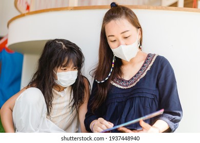 Asian Mother Reading Book With Her Children Kid Lying On Floor At Home During Covid19 Stay Home.Mom Telling Story To Her Child At Kids Club.medical Mask.study Bible At Home,Teacher Family Activities