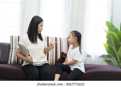 Asian Mother Scolding Daughter, Do Not Use The Laptop Computer Idea Concept