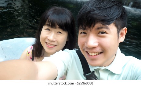 Asian Mother And Son Take Selfie