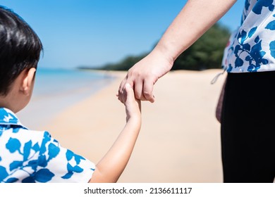 Asian Mother And Son Walking Hand In Hand On The Beach Of The Sea Concept Of Mother And Child Relationship And Mother's Day
