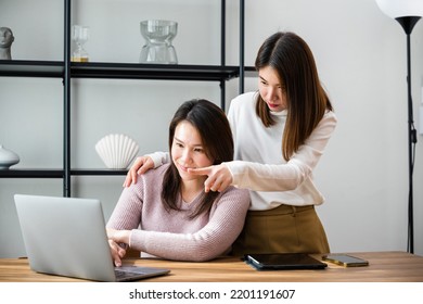 Asian Mother And Teenage Daughter Looking At Laptop Computer At Home Office, Happy Family Work Together, Middle Age Woman And Teen They Shoping Online On Computer