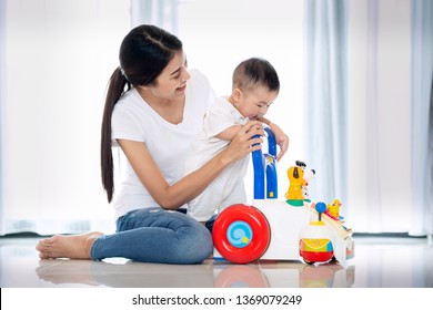 Asian Mother Traning Walking To Her Baby By Walking Toy