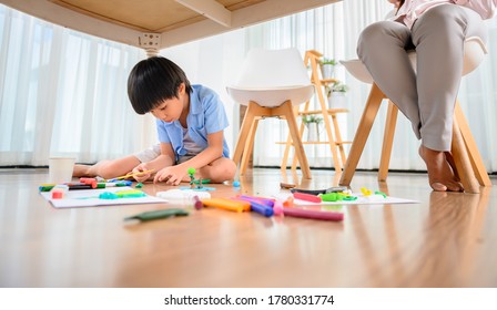 Asian Mother Work Home Together With Son. Mom Online Working And Kid Play Dough Under Table. Woman Lifestyle And Family Activity.