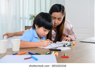 Asian Mother Working At Home Together With Son. Mom And Kid Drawing Picture And Color Painting Art. Woman Lifestyle And Family Activity.