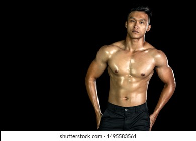 Asian muscle men posing muscle front on the black background. Body gym big chest and shoulder and bicep. Healthy fitness body type.