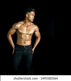 Asian Muscle Men Posing Muscle Front On The Black Background. Body Gym Big Chest And Shoulder And Bicep. Healthy Fitness Body Type.