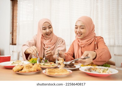 Asian Muslim beautiful woman family making iftar dua to break fasting during Ramadan. - Shutterstock ID 2258640817