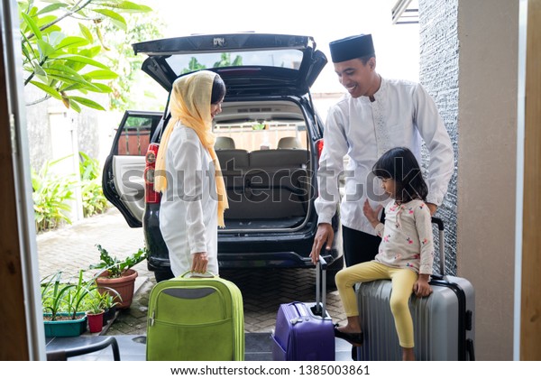 asian muslim\
family with suitcase prepare to go. concept of family travelling\
for eid mubarak\
celebration
