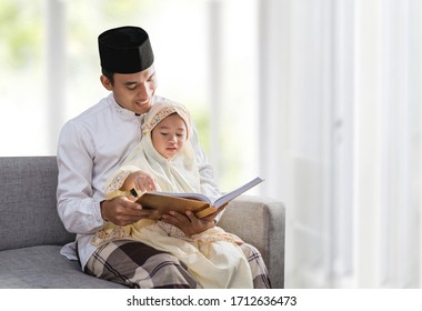 asian muslim father read quran with his daughter - Powered by Shutterstock