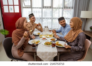 Asian Muslim Friend And Family Break Fasting Together