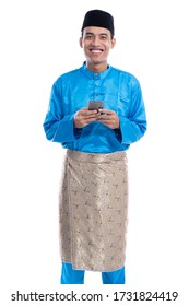 asian muslim man with mobile phone wearing koko melayu isolated over white