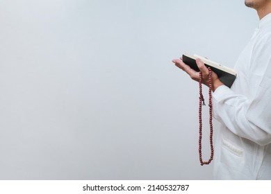 Asian Muslim Man Reading A Al Quran On White Background, Learn To Read Alquran Concept.