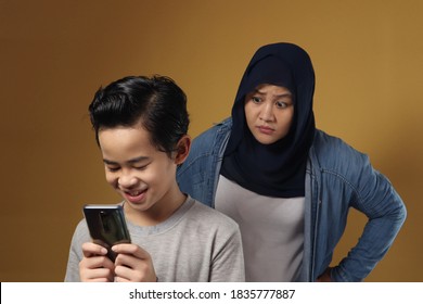 Asian Muslim Mother Shocked And Worried To See Her Son's Phone, Bad Content For Kid Concept