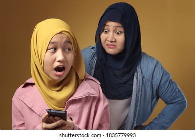 Asian muslim mother shocked and worried to see her daughters phone, bad content for kid concept