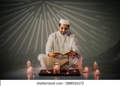 Asian Muslim Prayer Sitting In Mosque And Read Holy Al Quran Book. Muslim Man Study Holy Al Quran Book During Ramadan