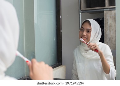 Asian Muslim Woman Brush Her Teeth
