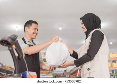 Asian Muslim Woman Buying Some Halal Product At Supermarket