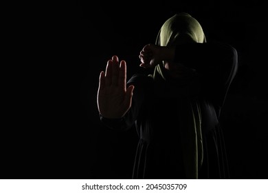 Asian Muslim Woman Cover Her Face With Her Hand, Stop Violence Against Women Concept.