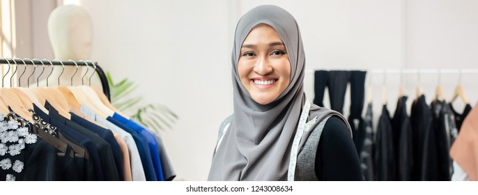 Asian muslim woman designer as a startup business owner in her tailor shop, panoramic web banner