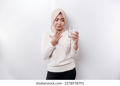 An Asian Muslim woman feels so thirsty because of the hot weather during the summer season while fasting