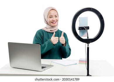 Asian Muslim Woman With Laptop And Mobile Phones With Lighting Equipment Make A Vlog Isolated Over White Background