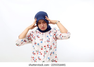 Asian muslim woman suffering from head ache. Hand holding head. Isolated on white background - Shutterstock ID 2255316441
