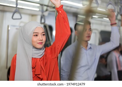 Asian muslim woman wear hijab head scarf in the metro or train subway, public transport - Powered by Shutterstock